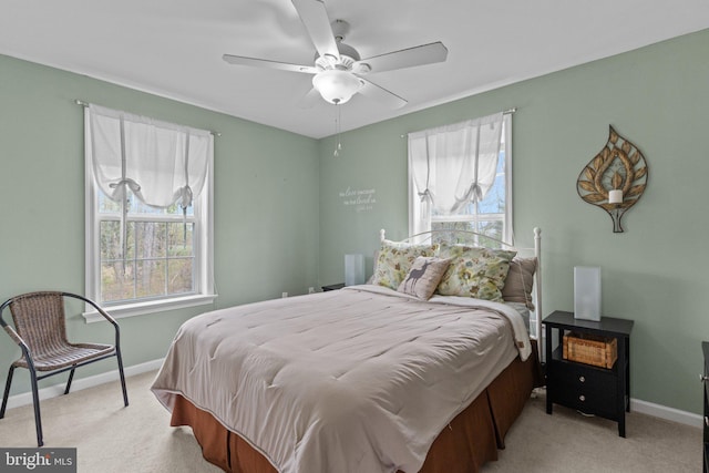bedroom with ceiling fan, baseboards, and carpet