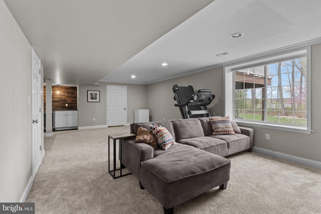 living area with recessed lighting, baseboards, visible vents, and light colored carpet