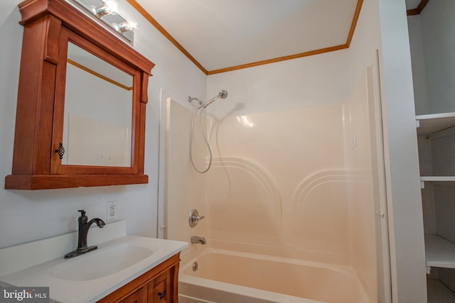 bathroom featuring shower / washtub combination, ornamental molding, and vanity