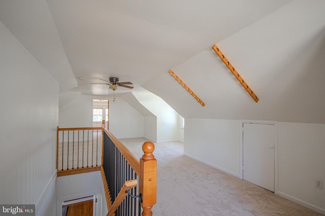 additional living space with vaulted ceiling, baseboards, ceiling fan, and carpet flooring