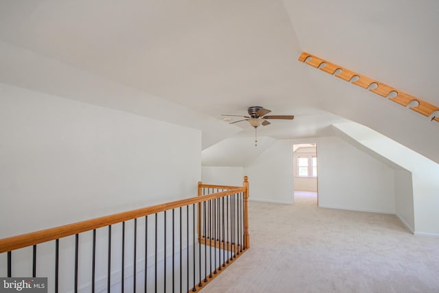 additional living space featuring baseboards, a ceiling fan, carpet, and vaulted ceiling