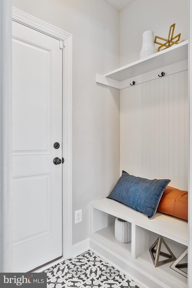 mudroom with tile patterned floors and baseboards