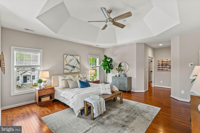 bedroom featuring baseboards, visible vents, and hardwood / wood-style floors