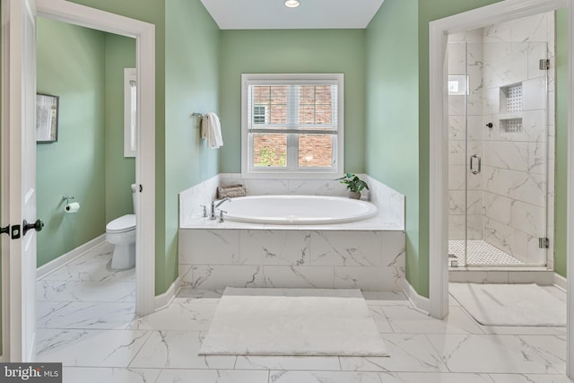 full bathroom with toilet, marble finish floor, baseboards, a shower stall, and a garden tub
