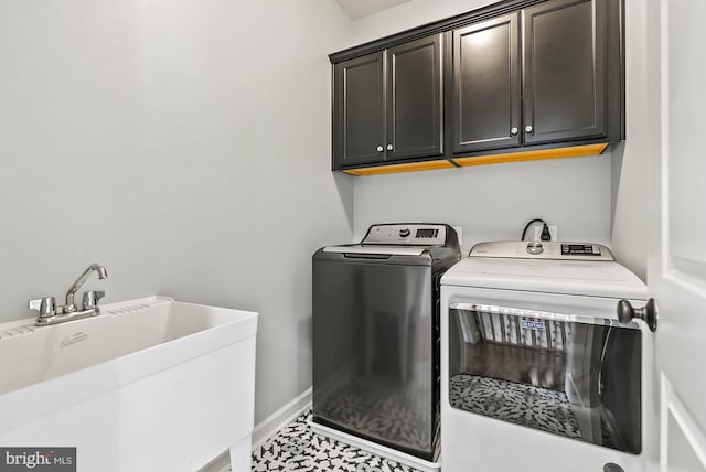 4950 34th St N, Arlington, VA 22207 - clothes washing area with baseboards, a sink, cabinet space, and washer and clothes dryer