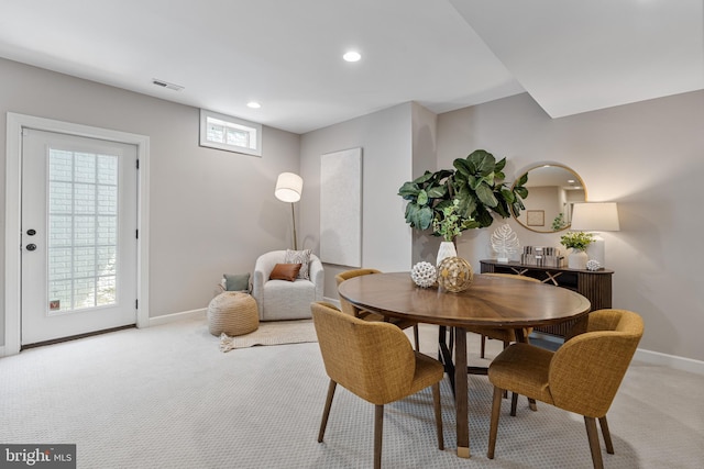 dining room with recessed lighting, baseboards, light colored carpet, and visible vents
