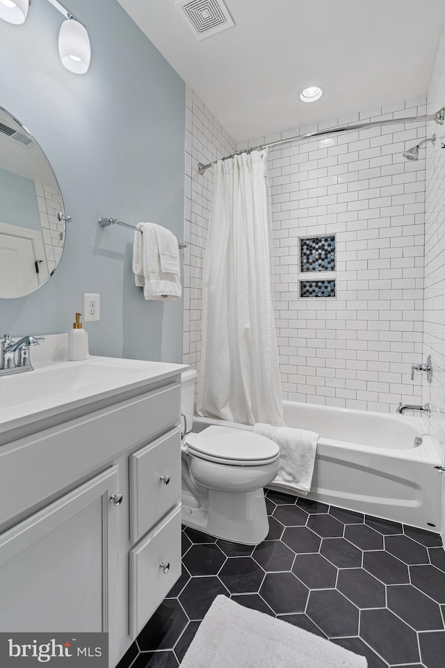 bathroom featuring tile patterned floors, shower / bath combo with shower curtain, toilet, and visible vents