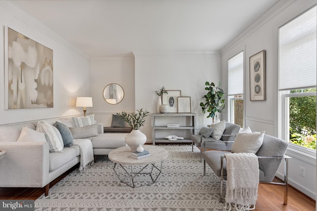 living area with ornamental molding and wood finished floors