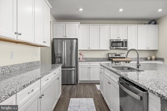 7269 Liberty Ct, Ruther Glen, VA 22546 - kitchen featuring light stone countertops, a sink, stainless steel appliances, white cabinets, and dark wood-style floors