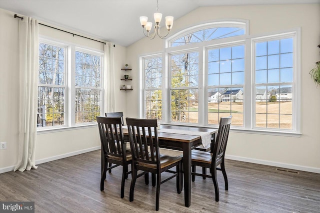 7269 Liberty Ct, Ruther Glen, VA 22546 - dining area with vaulted ceiling, a notable chandelier, visible vents, and wood finished floors