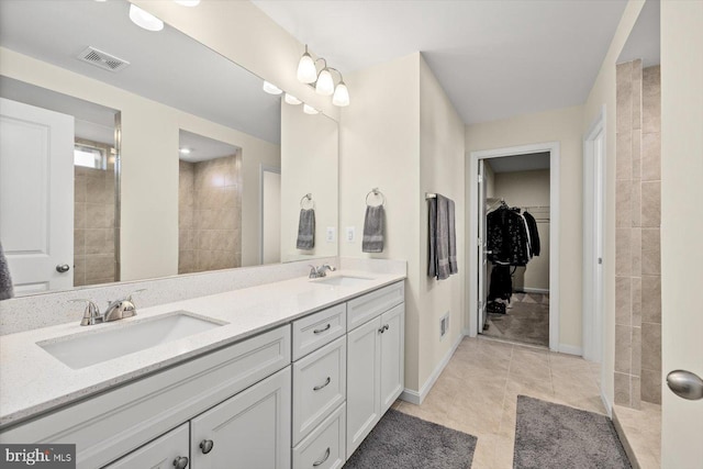 7269 Liberty Ct, Ruther Glen, VA 22546 - bathroom featuring a spacious closet, visible vents, a sink, and double vanity