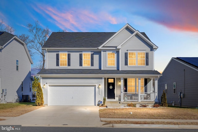 7269 Liberty Ct, Ruther Glen, VA 22546 - view of front of home with a porch, concrete driveway, and an attached garage