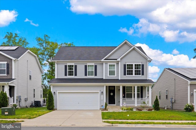 7269 Liberty Ct, Ruther Glen, VA 22546 - view of front of property featuring covered porch, a garage, central AC, concrete driveway, and a front yard