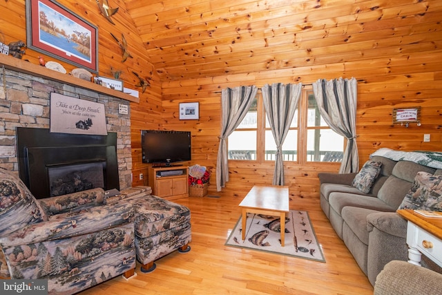 134 Highland Ave, Accident, MD 21520 - living area featuring high vaulted ceiling, a glass covered fireplace, wooden walls, and wood finished floors