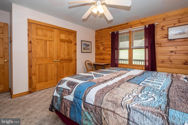 134 Highland Ave, Accident, MD 21520 - bedroom with wood walls, light colored carpet, baseboards, a ceiling fan, and a closet
