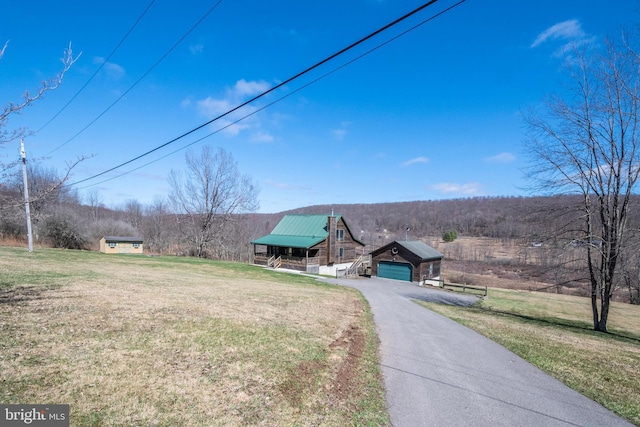 134 Highland Ave, Accident, MD 21520 - exterior space featuring an outbuilding, a front yard, aphalt driveway, and a detached garage