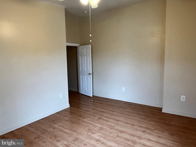 1921 W Diamond St, Philadelphia, PA 19121 - empty room featuring a ceiling fan, a towering ceiling, baseboards, and wood finished floors
