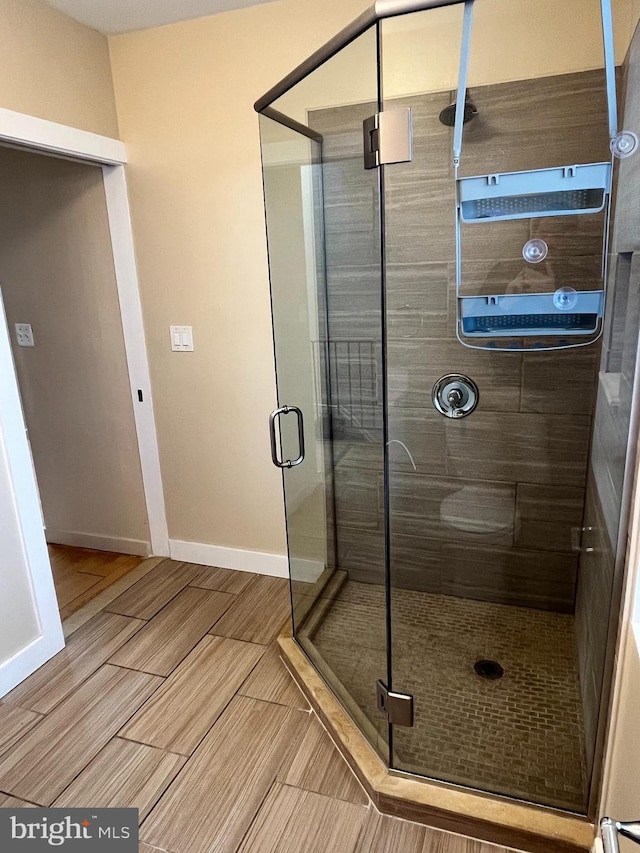 1921 W Diamond St, Philadelphia, PA 19121 - bathroom featuring wood finish floors, baseboards, and a shower stall
