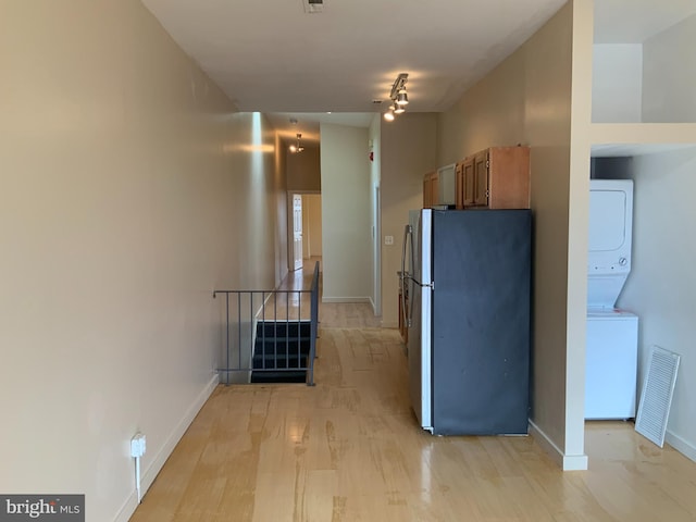 1921 W Diamond St, Philadelphia, PA 19121 - kitchen featuring light wood-type flooring, stacked washer / drying machine, baseboards, visible vents, and freestanding refrigerator