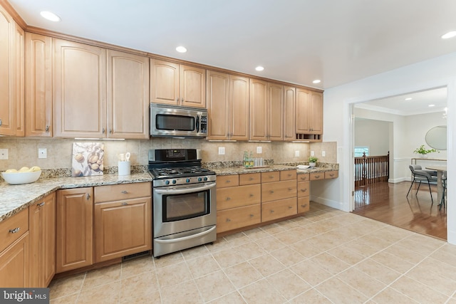 142 N French St, Alexandria, VA 22304 - kitchen with appliances with stainless steel finishes, backsplash, light tile patterned floors, light stone countertops, and recessed lighting