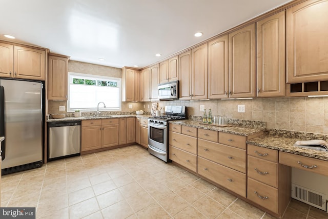 142 N French St, Alexandria, VA 22304 - kitchen featuring stainless steel appliances, stone countertops, tasteful backsplash, light tile patterned floors, and recessed lighting