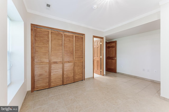 142 N French St, Alexandria, VA 22304 - unfurnished bedroom featuring ornamental molding, a closet, baseboards, and light tile patterned flooring
