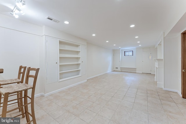 142 N French St, Alexandria, VA 22304 - below grade area with built in shelves, recessed lighting, light tile patterned flooring, and baseboards