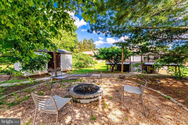 142 N French St, Alexandria, VA 22304 - view of yard with an outdoor fire pit, a storage shed, an outdoor structure, and a deck