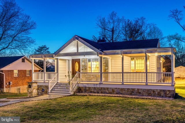 142 N French St, Alexandria, VA 22304 - view of front facade with covered porch, a front lawn, and a chimney