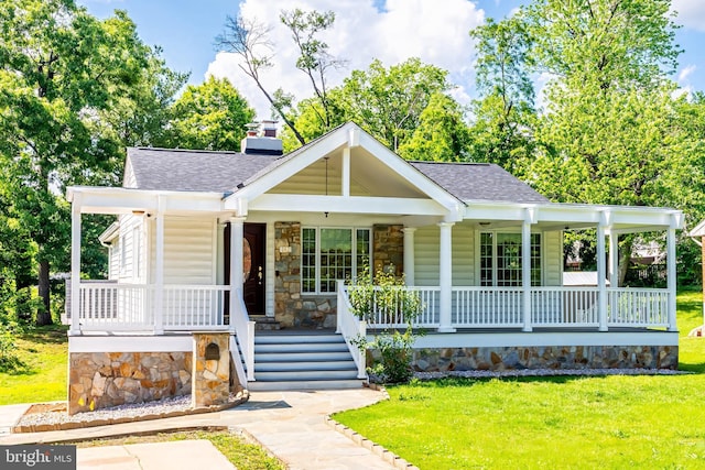 142 N French St, Alexandria, VA 22304 - view of front of property with covered porch, a shingled roof, a front yard, and stone siding