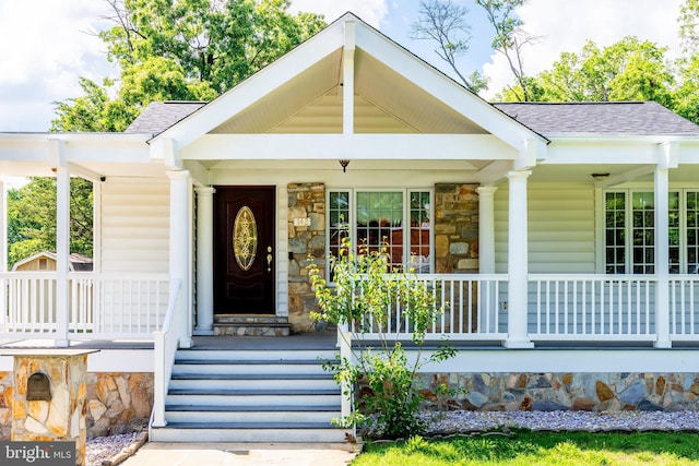 142 N French St, Alexandria, VA 22304 - property entrance with a porch, roof with shingles, and stone siding