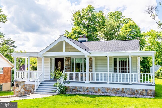 142 N French St, Alexandria, VA 22304 - view of front facade featuring covered porch, a shingled roof, a front lawn, and stone siding