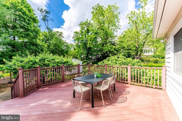 142 N French St, Alexandria, VA 22304 - deck with outdoor dining space and view of wooded area