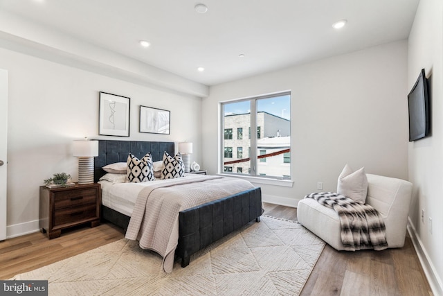 bedroom featuring light wood-type flooring, baseboards, and recessed lighting