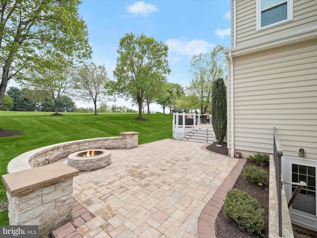 view of patio / terrace featuring a deck and a fire pit