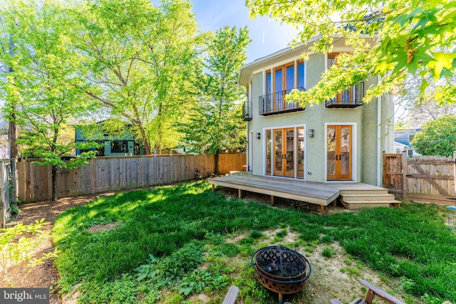 1805 N Calvert St, Arlington, VA 22201 - back of house with a balcony, stucco siding, french doors, a fire pit, and a wooden deck