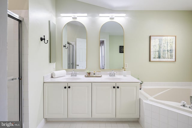 6129 White Marble Ct, Clarksville, MD 21029 - bathroom featuring double vanity, a garden tub, tiled shower, and a sink