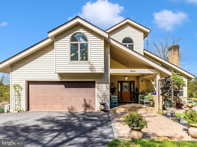 10334 Harp Rd, Walkersville, MD 21793 - view of front facade featuring an attached garage, driveway, and a chimney