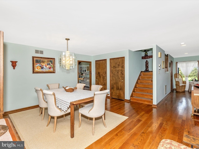 10334 Harp Rd, Walkersville, MD 21793 - dining area with stairway, an inviting chandelier, wood finished floors, and visible vents