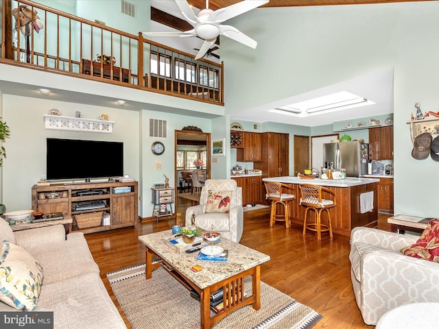 10334 Harp Rd, Walkersville, MD 21793 - living room featuring a high ceiling, a ceiling fan, wood finished floors, and visible vents