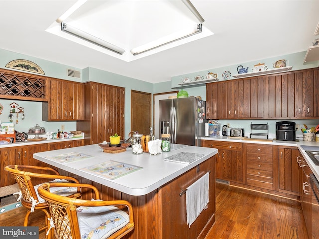 10334 Harp Rd, Walkersville, MD 21793 - kitchen with dark wood finished floors, visible vents, stainless steel fridge with ice dispenser, light countertops, and a kitchen island