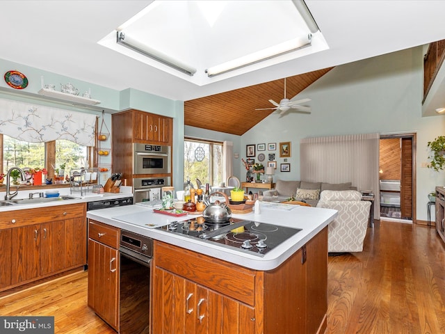 10334 Harp Rd, Walkersville, MD 21793 - kitchen with light wood finished floors, stainless steel double oven, light countertops, a sink, and black electric stovetop