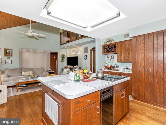 10334 Harp Rd, Walkersville, MD 21793 - kitchen with brown cabinetry, ceiling fan, open floor plan, and light wood-style floors