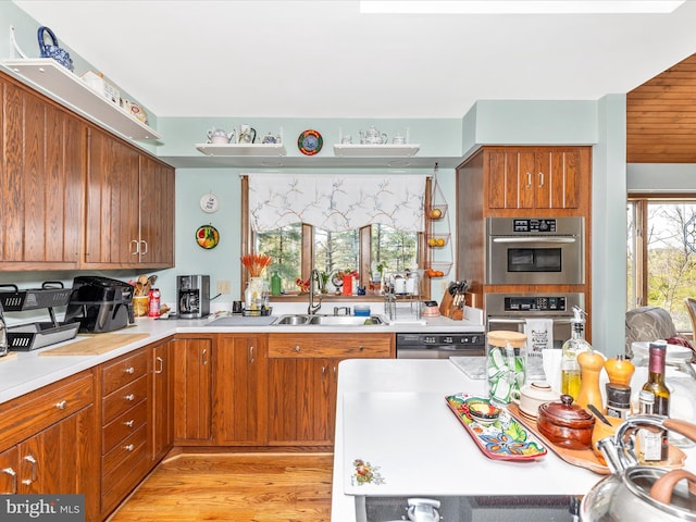 10334 Harp Rd, Walkersville, MD 21793 - kitchen featuring a sink, brown cabinets, stainless steel double oven, light wood-style floors, and light countertops