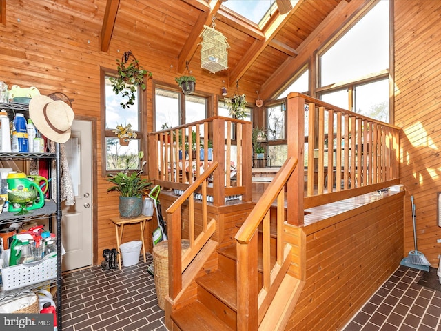 10334 Harp Rd, Walkersville, MD 21793 - staircase featuring a skylight, wooden walls, brick patterned floor, and wood ceiling