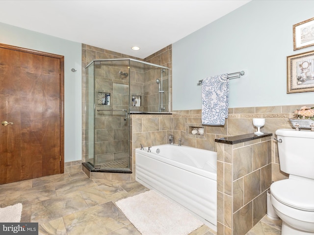 10334 Harp Rd, Walkersville, MD 21793 - bathroom featuring a shower stall, toilet, a garden tub, and tile walls