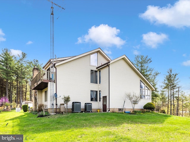 10334 Harp Rd, Walkersville, MD 21793 - view of side of property with a lawn, central AC unit, and a balcony