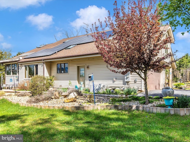 10334 Harp Rd, Walkersville, MD 21793 - view of front facade featuring roof mounted solar panels, aphalt driveway, a front lawn, an attached garage, and roof with shingles