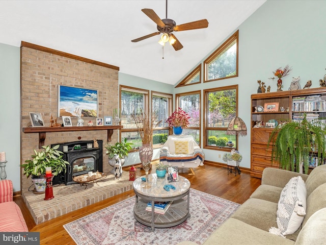 10334 Harp Rd, Walkersville, MD 21793 - living room featuring baseboards, a ceiling fan, wood finished floors, high vaulted ceiling, and a wood stove