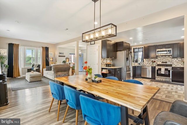 2205 Elsinore Ave, Baltimore, MD 21216 - dining area featuring light wood-style flooring and recessed lighting